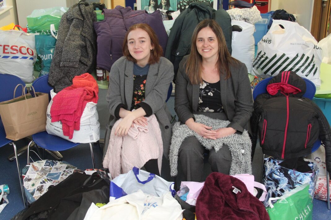 Sutton Girls’ sixth-former Maryam Mohanna with assistant headteacher Michelle Lucas and just some of the clothes collected for People in Motion.