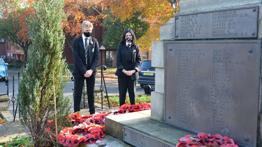 Students from Bishop Vesey's Grammar School pay their respects at Sutton Coldfield's war memorial.