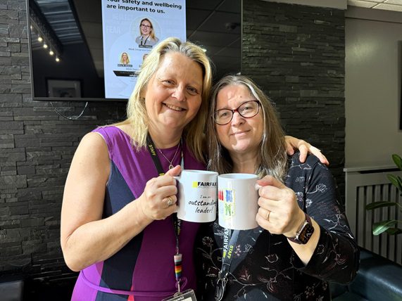 Helen Williams, Assistant Principal for Inclusion and Participation with Deputy Head of Academy Rachel Boyce and mugs celebrating the glowing Ofsted report.